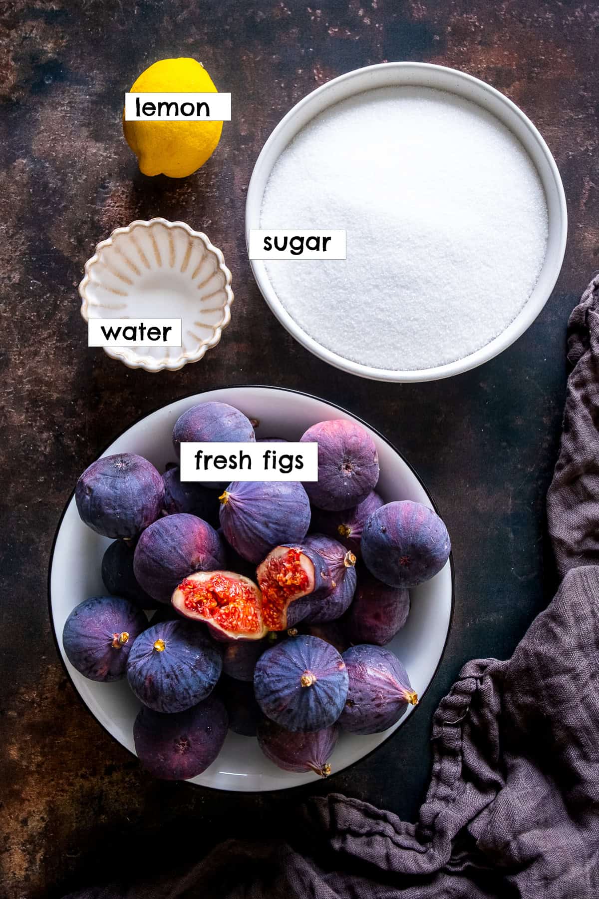 Ingredients for fig jam: fresh figs, sugar, lemon, and water.