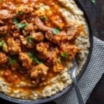 Pinterest image of Hunkar Begendi showing lamb stew served over creamy eggplant puree.