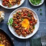 Pinterest pin image showing plated ground beef and eggs breakfast with onions, peppers, and a soft egg yolk, with recipe title text overlay.