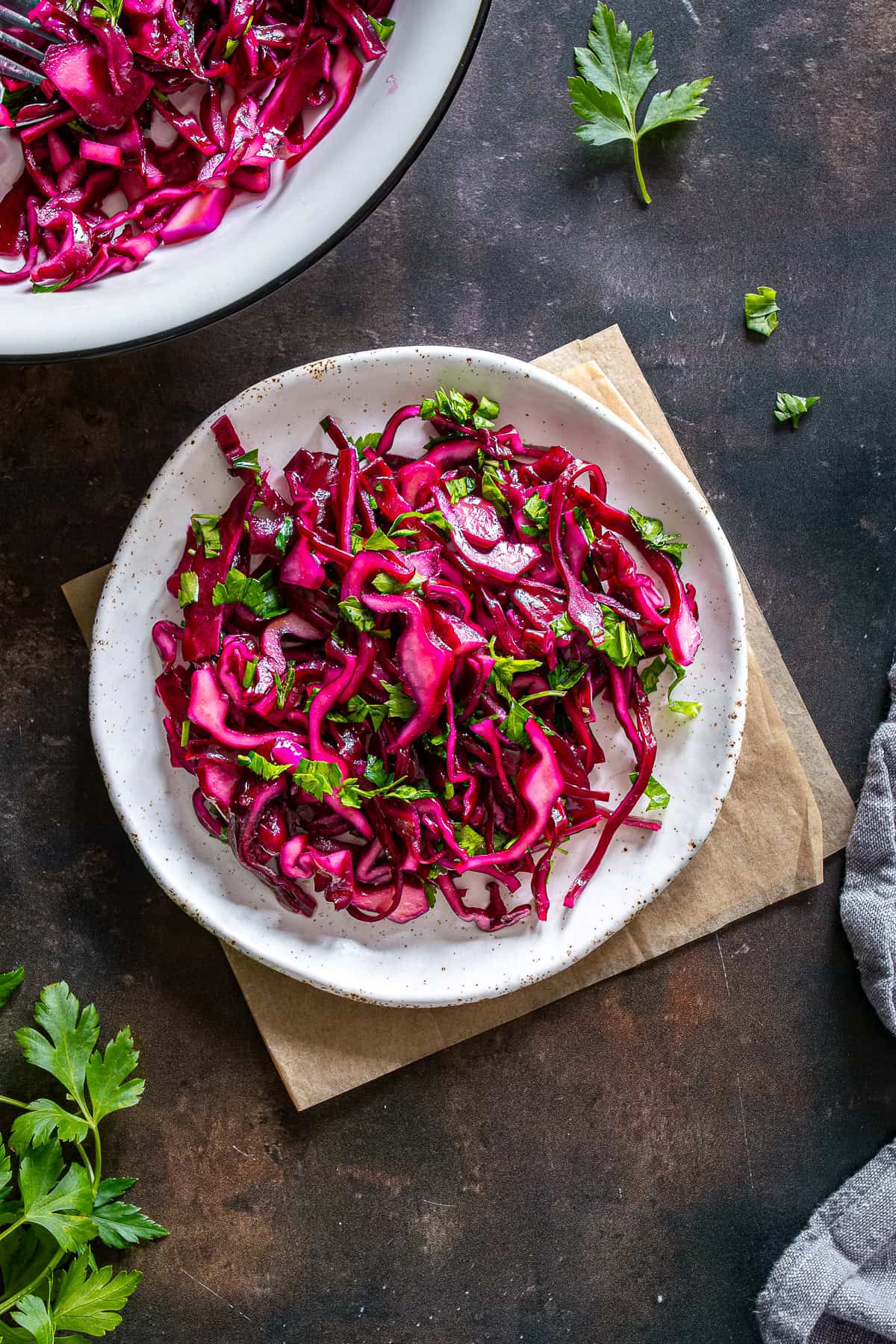 Turkish red cabbage salad with parsley served on a plate with a vibrant pink color.