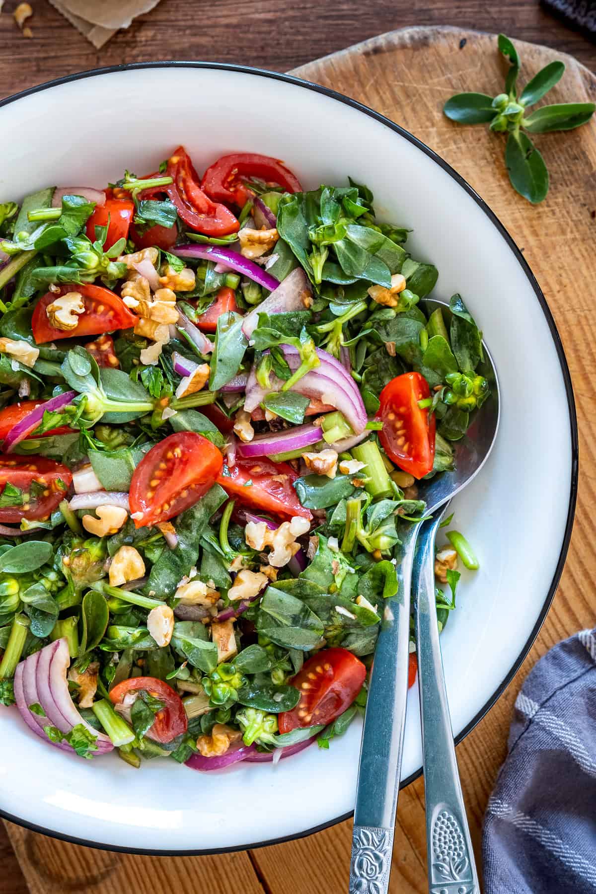 Close-up of Turkish purslane salad with purslane, cherry tomatoes, red onion and walnuts.
